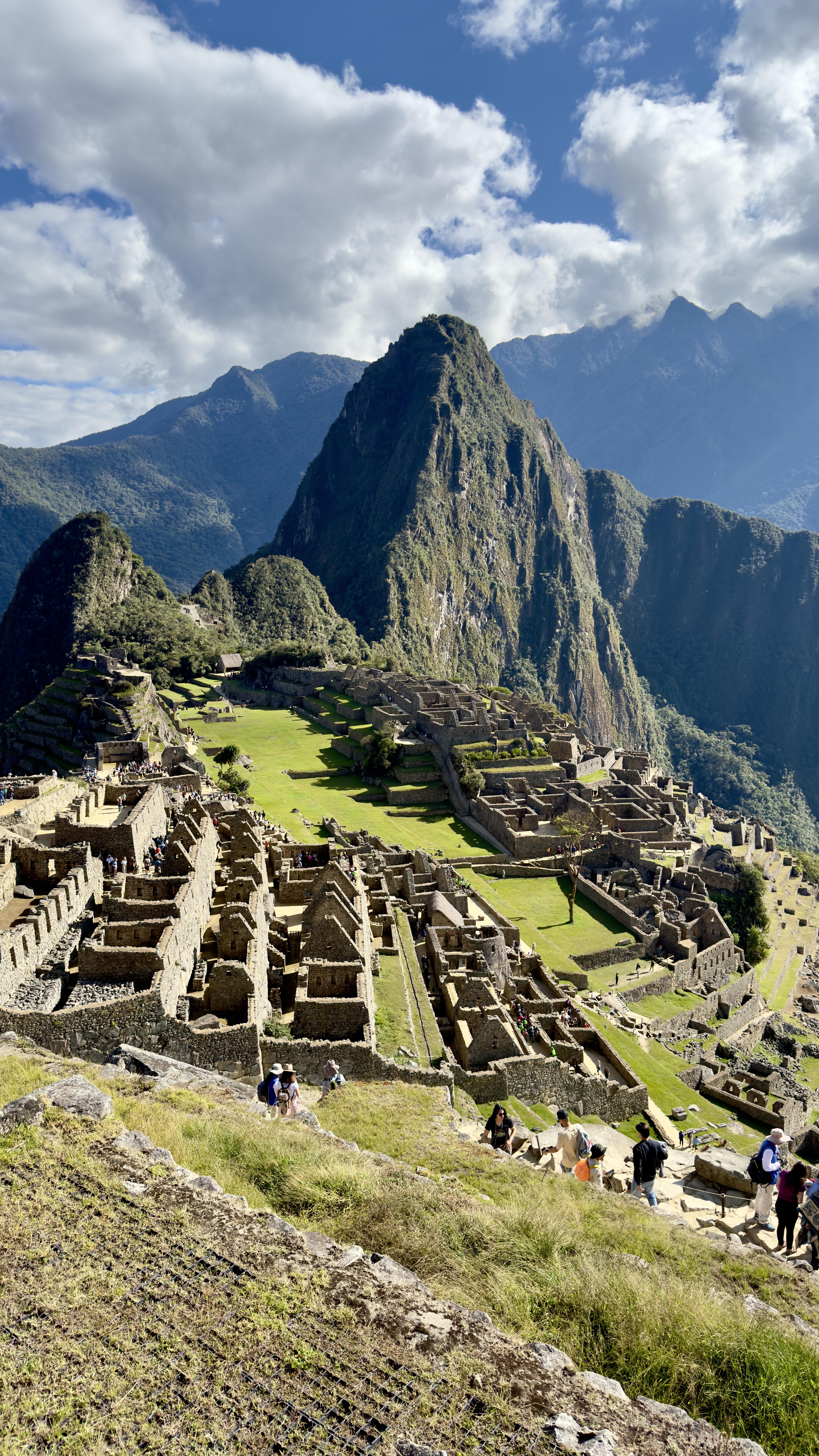 Ancient stone ruins of Machu Picchu citadel with Huayna Picchu peak rising behind