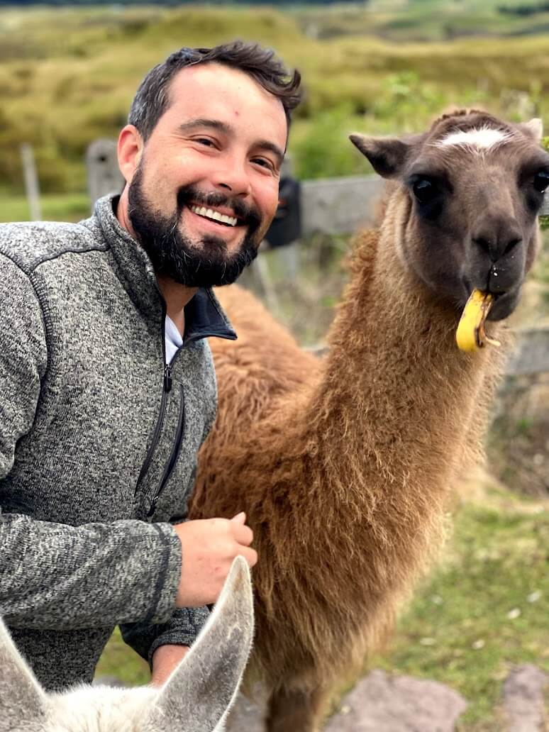 Brendon with a llama in South America